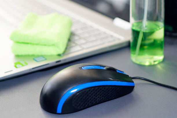 Computer mouse and bottle of sanitizer and a laptop on the desktop in the office. Prevention and control of coronavirus infection and other viral diseases. Computer mouse and a bottle of sanitizer and a laptop on the desktop in the office. Prevention and control of coronavirus infection and other viral diseases. office fogging stock pictures, royalty-free photos & images