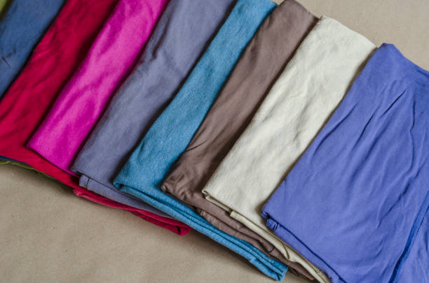 istock An assortment of multi-colored t-shirts on a store counter. 1223217679
