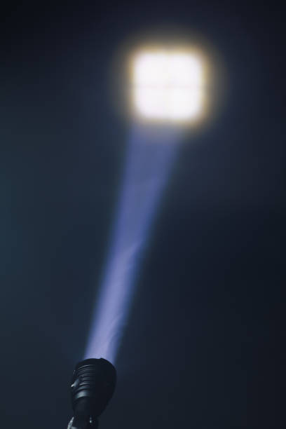 ray of pocket flashlight in smoke, copy-space background