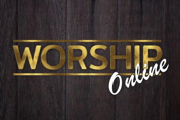 Photo of The word WORSHIP online concept written in gold texture on wooden background.