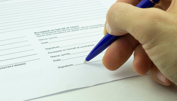 istock A man signs a contract with a blue ballpoint pen. 1223220393
