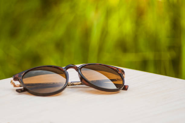 istock Brown sunglasses in the foreground with grass background. 1223220696