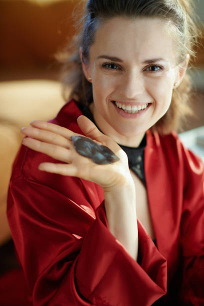 smiling modern housewife showing hydrogel lip mask