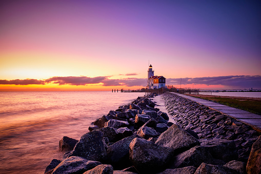 The Paard van Marken lighthouse is a lighthouse near the harbor town of Marken in North Holland on the IJsselmeer. It was built in 1839. Seen here during a beautiful sunrise.