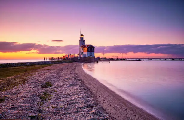 The Paard van Marken lighthouse is a lighthouse near the harbor town of Marken in North Holland on the IJsselmeer. It was built in 1839. Seen here during a beautiful sunrise.