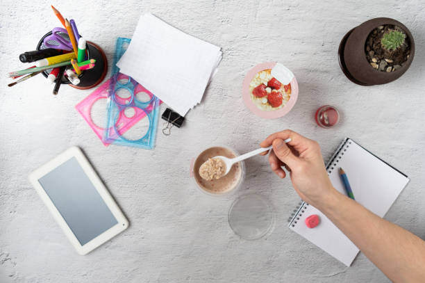 istock Breakfast at the workplace. Oatmeal with strawberries. A wholesome breakfast on during work. 1223222221
