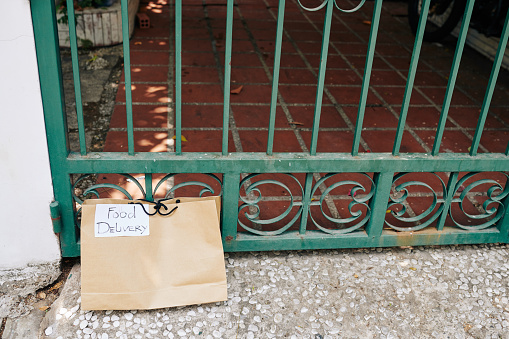 Paper package with food delivered to gates of customer