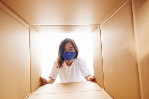 istock Woman looking inside of cardboard box 1223224146
