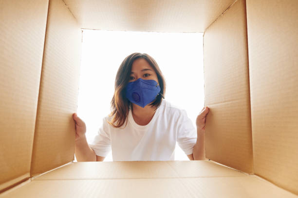 istock Young woman unpacking order 1223224154