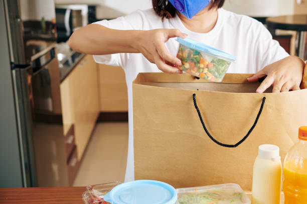 istock Woman unpacking bag 1223224158