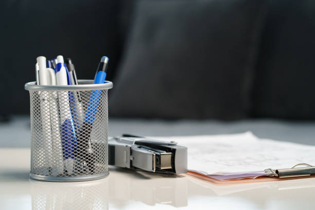 Metal pen holder on a white desk
