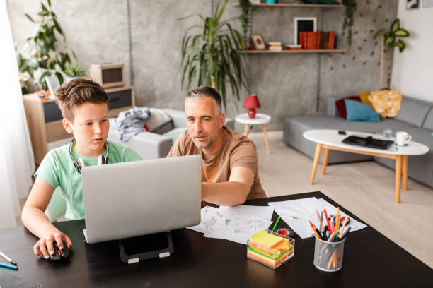 istock Father showing to his son how to connect on a online teaching video class 1223225501