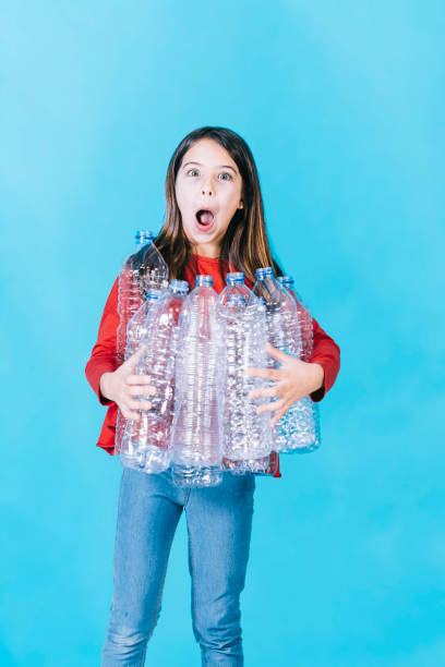 istock Little girl with plastic bottles 1223226530