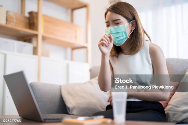Young Asian Woman Wearing Mask Is Work At Home She Coughed And Sore Throat Stock Photo - Download Image Now