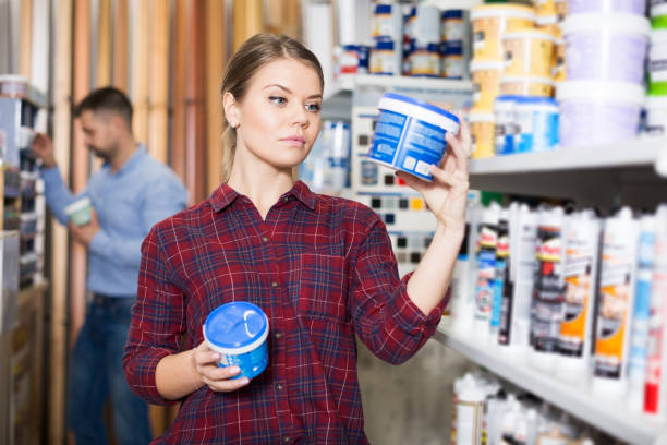 istock Woman is choosing with paint for repair 1223230620