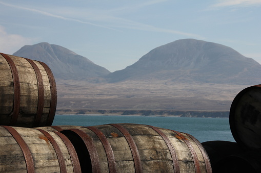 Whisky casks on Islay with the Paps of Jura in the background