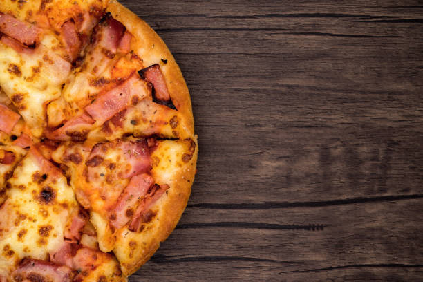 istock Top view, pizza on dark wooden background. 1223232531