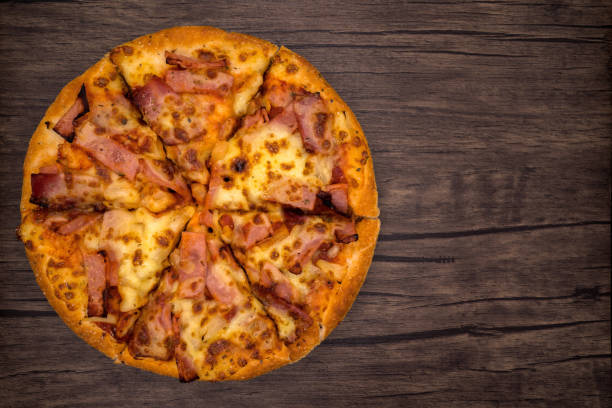 istock Top view, pizza on dark wooden background. 1223232610