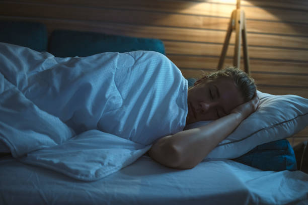 istock Woman peacefully sleeping in bed at night 1223234018