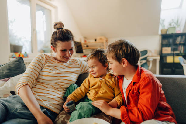 istock Mother and sons watching tv together 1223234028