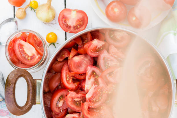 istock Sliced tomatoes in the pot,  tomatoes are prepared for preserves 1223234231