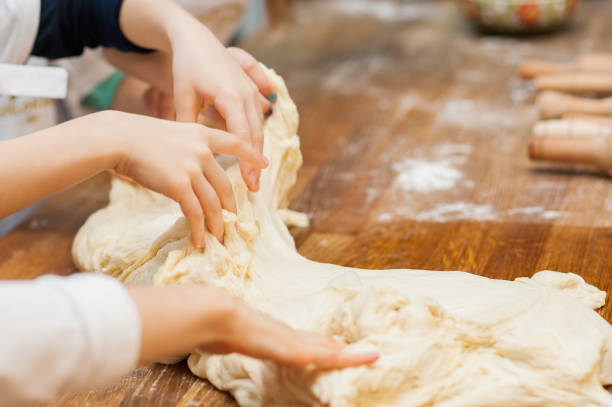 istock Small children take the dough. Hands close up 1223235549