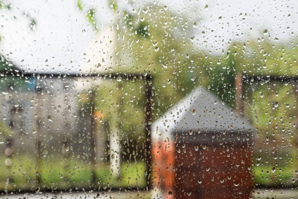 istock Raindrops on window pane. Blurred background outside the window in the rain. 1223236218