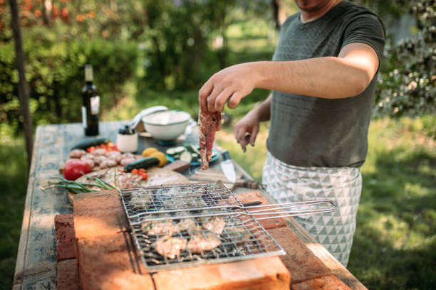 istock Young Man Preparing Barbecue Outdoor 1223237189