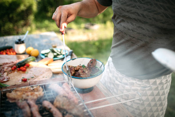 istock Young Man Preparing Barbecue Outdoor 1223237277