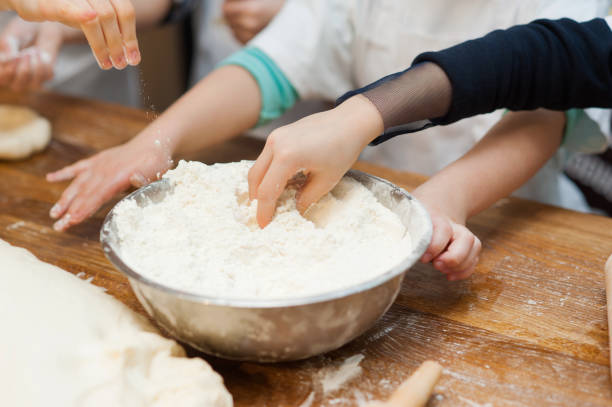 istock Children's hands take the flour from the plate 1223238029