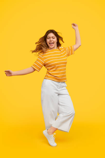 istock Excited woman dancing with closed eyes 1223240172