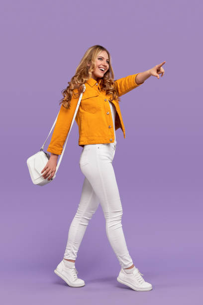 istock Cheerful woman pointing at distance 1223240239