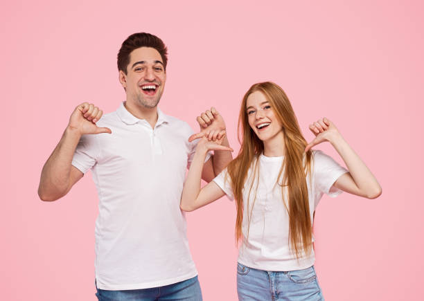 istock Happy optimistic young couple on pink background 1223240290