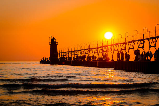 South Havens lighthouse and pier on Lake Michigan during sunset stock photo