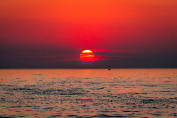 Sun setting on the horizon of Lake Michigan in South Haven stock photo
