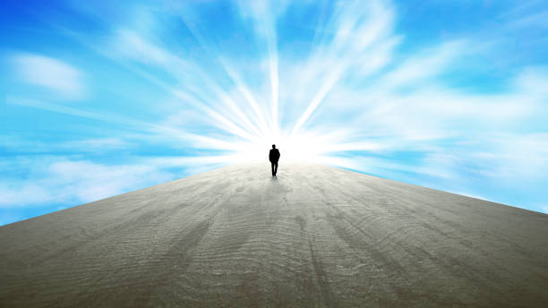 istock Business man walking towards a better future. Bright light at the end 1223241040