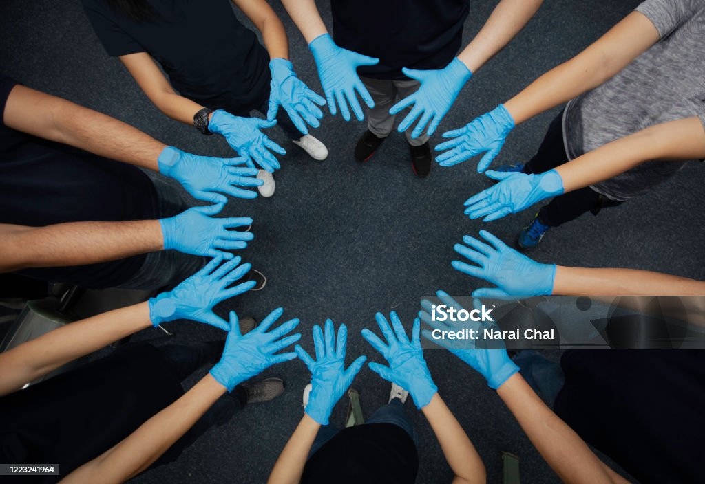 Close up group of hand with medical glove present Collaborate and teamwork Volunteer Stock Photo