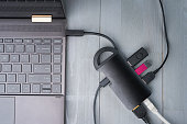 USB Type C adapter or hub connected to the laptop.