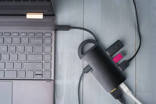 Photo of USB Type C adapter or hub connected to the laptop.