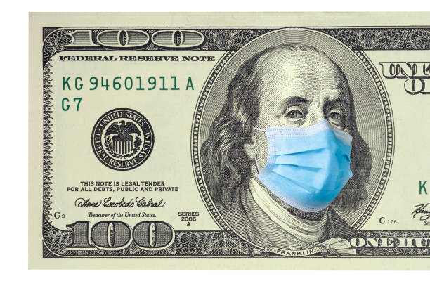 istock One hundred dollar bill with medical face mask on Benjamin Franklin. 1223242927