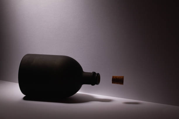 Luxury Black Glass of Rum on the white background. Levitating cork stopper.