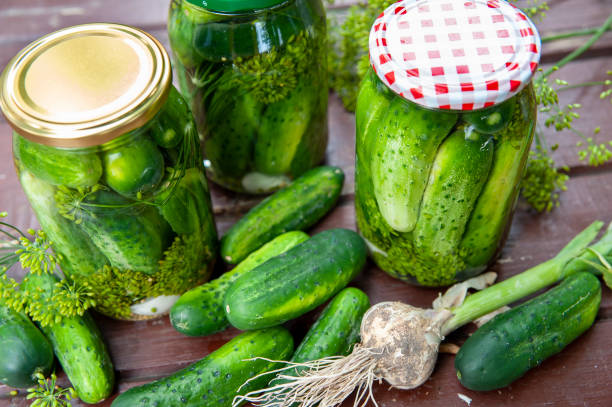 istock Homemade marinated cucumbers in glass jars on the table. 1223246622