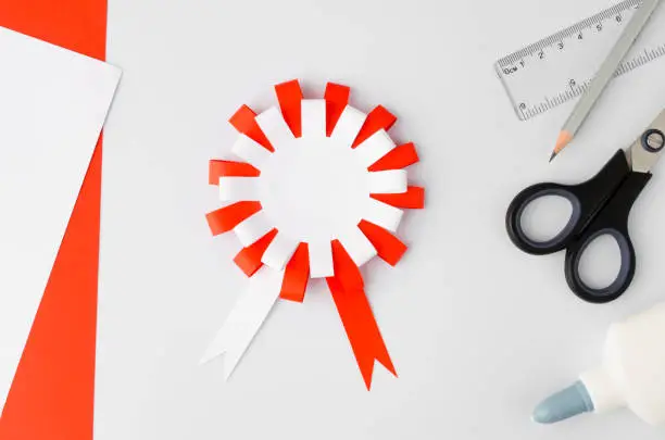 How to make polish paper cotillion at home. Step by step instruction. Step 12. National symbol of Poland. Scissors, glue, paper sheets.Top view