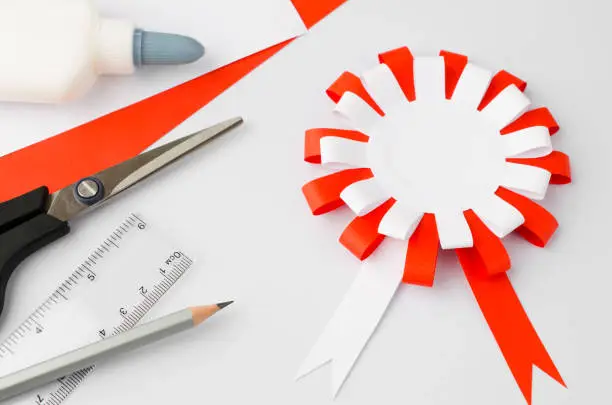 How to make polish paper cotillion at home. Step by step instruction. Step 14. National symbol of Poland. Scissors, glue, paper sheets.Top view