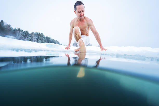 istock Young athletic man going to have ice bath in the winter lake 1223246823