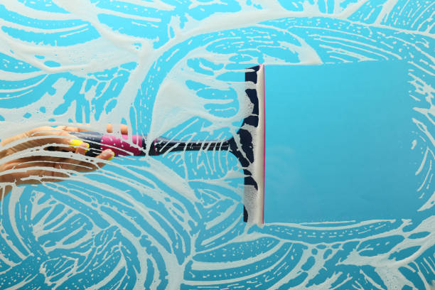 istock concept of window cleaning on blue background with copy space. 1223247059