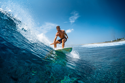 Ocean waves, senior man surfing on beach and healthy fitness lifestyle in Australia summer holiday. Elderly surfer swimming with surfboard, sea water exercise and relax in retirement travel vacation