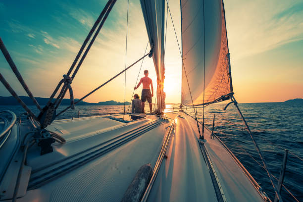 istock Young couple sailing on the boat at sunset 1223250317