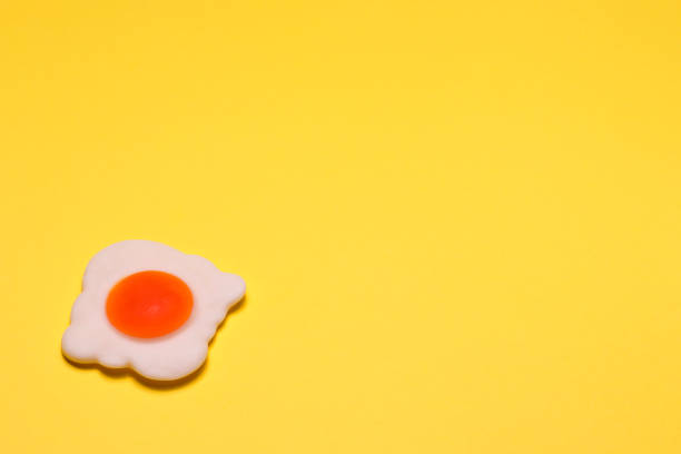 istock Jelly-fried egg is shot close-up on bright yellow background 1223251504
