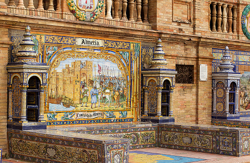 Seville, Spain - February 09, 2016: \nThe famous Plaza de España of Seville with tiled alcoves, each representing a different province of Spain. The province Almeria is represented in this picture.\n\nThe Plaza de España is a plaza in María Luisa Park, in Seville, Spain. Built in 1928, the Plaza de Espana is huge and takes on a half-elliptic shape, which represents the embrace of Spain and its ancient colonies. The square is surrounded by a long canal that is crossed by four bridges.